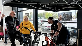 Fachberatung am Stand von Zweirad Illhardt im Autohaus Autowelt Peter. Ein Berater erklärt zwei Besuchern verschiedene Fahrräder. Im Hintergrund ist ein Škoda-Werbeplakat zu sehen.